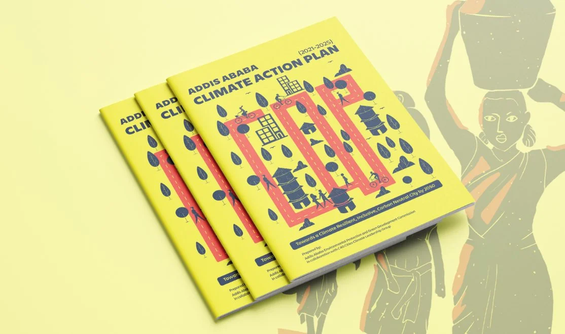 Printed copies of the Addis Ababa Climate Action Plan 2021–2025 with the yellow illustrated cover.