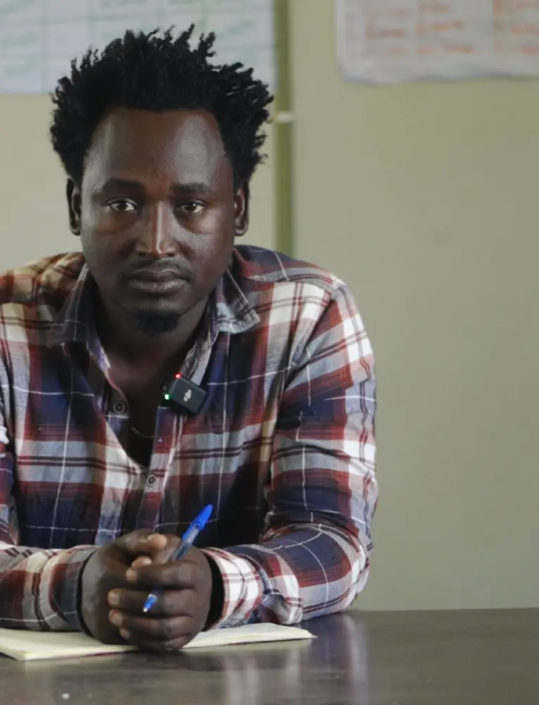 Portrait of Mr. Kulula seated at a desk.