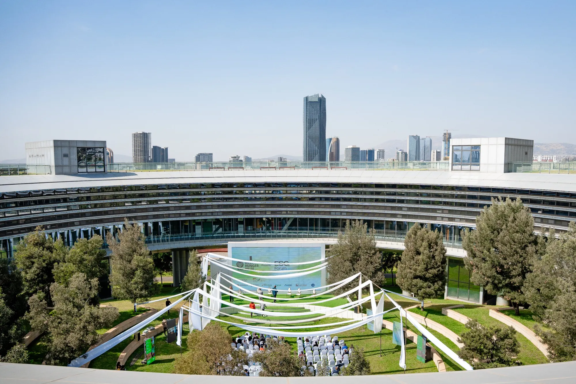 The forum from above: white canopies over the museum’s garden amphitheatre, the Addis Ababa skyline beyond.