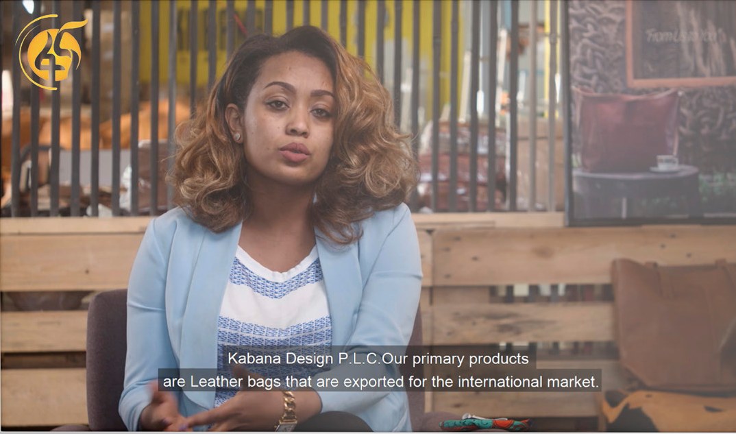 TV spot still: a young entrepreneur from Kabana Design speaks to camera about the leather bags her company exports.