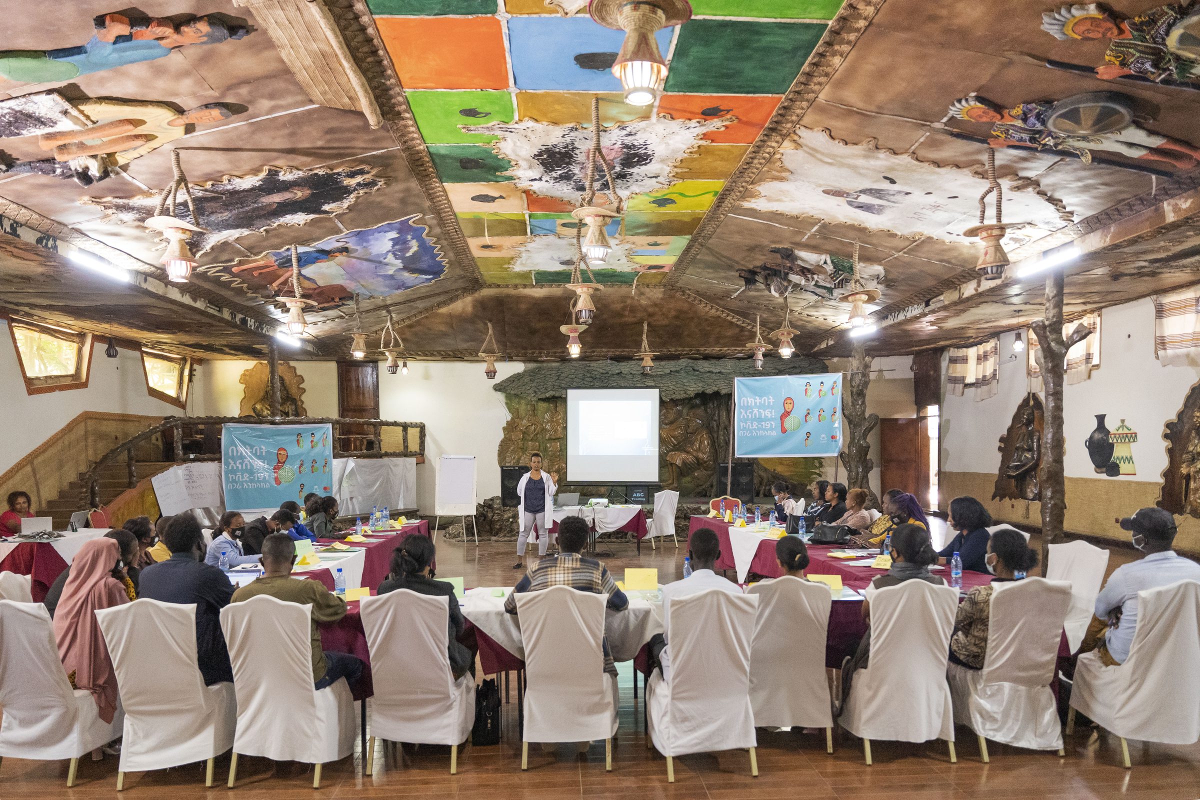 A community health event in a large decorated hall.