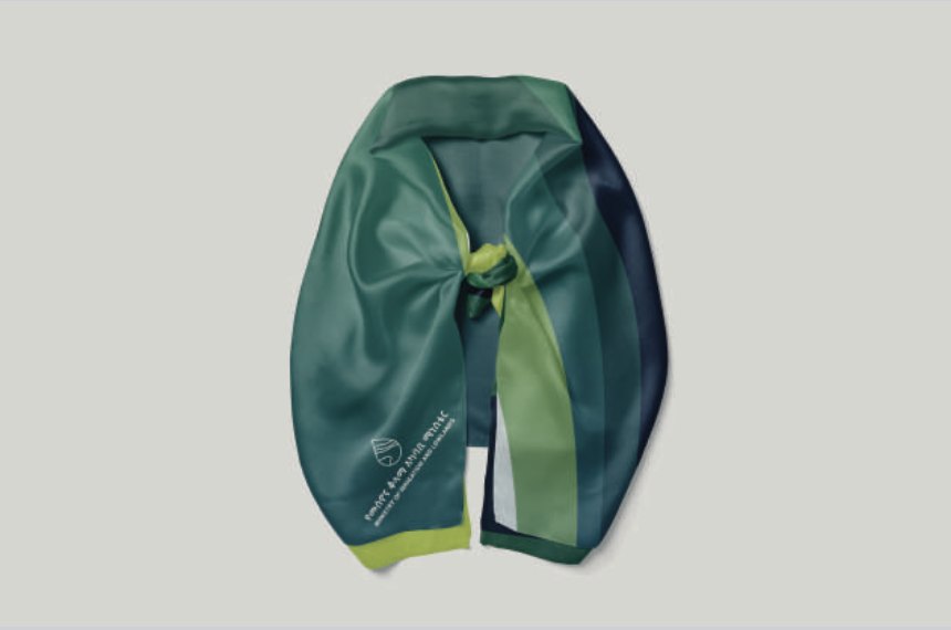 The MiLLS scarf laid flat, in bands of teal, navy and lime.