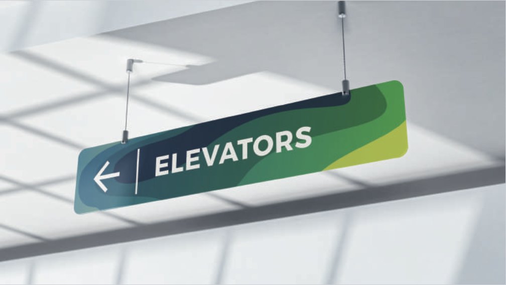 A hanging sign reading Elevators with an arrow, printed on the flowing brand pattern.