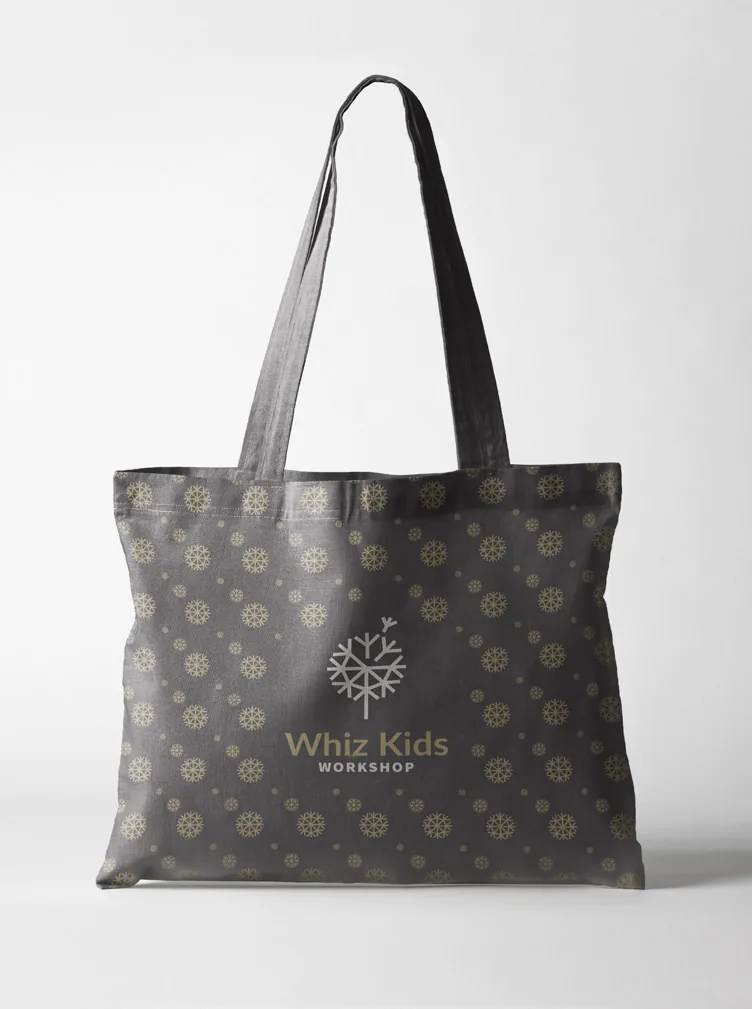 A grey tote bag patterned with gold dandelion heads and the Whiz Kids logo.