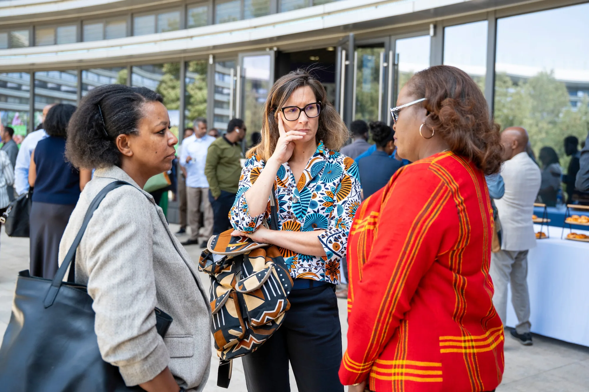 Three participants in conversation outside the venue at the ESG Forum.