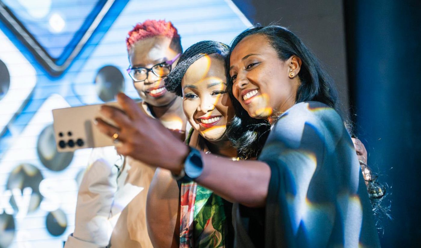 Guests taking a selfie with a Galaxy phone at the Samsung launch event.